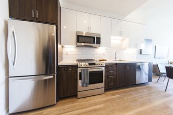 a kitchen with stainless steel appliances and white cabinets